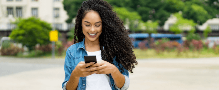 girl outside to boost cell signal