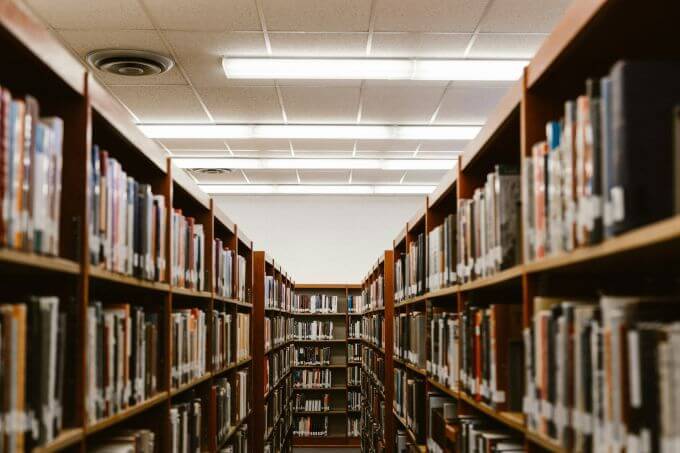 Rows of bookshelves in a school library, where cell signal can often be weak or blocked.